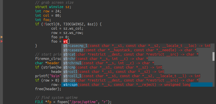 A C code file, with the letters &ldquo;st&rdquo; are written. A pop-up below the cursor displays options like &ldquo;strcat&rdquo;, &ldquo;strchr&rdquo;, &ldquo;strcmp&rdquo; and more.